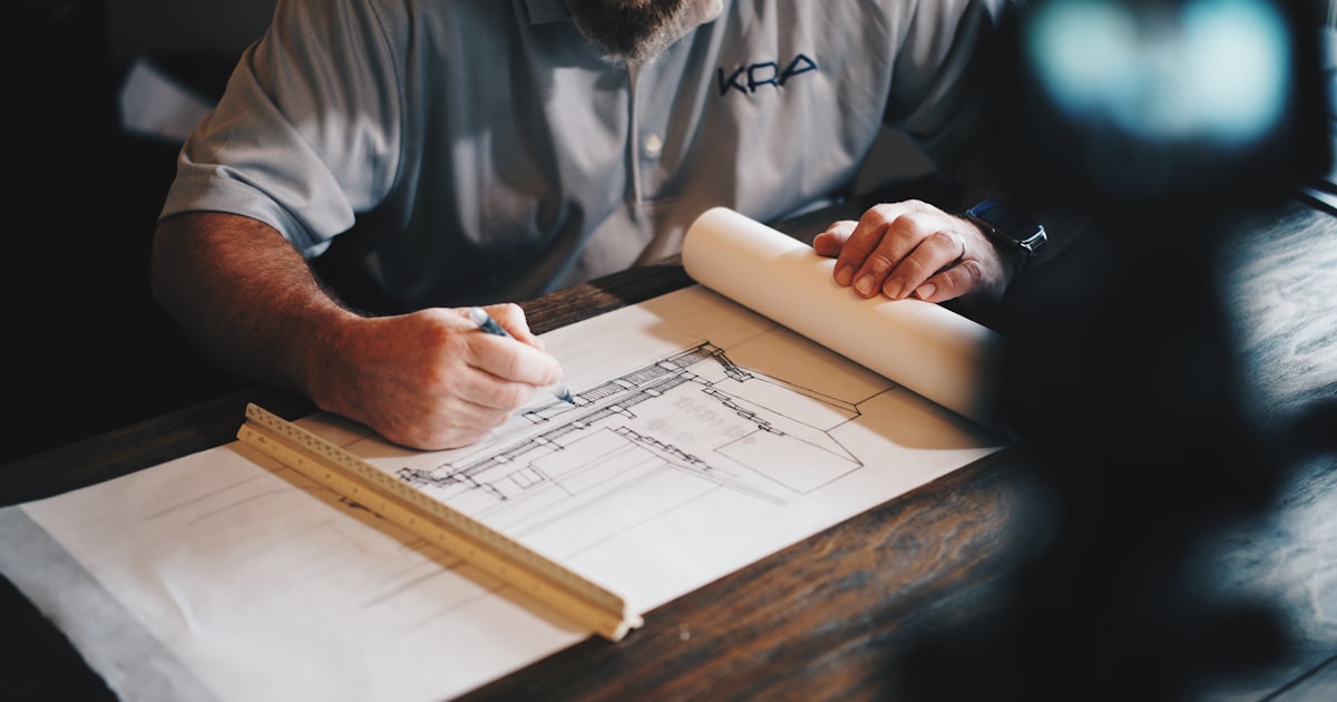 Architect reviewing design blueprints at a workstation