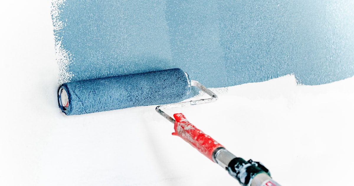 Professional applying protective sealant to a finished surface